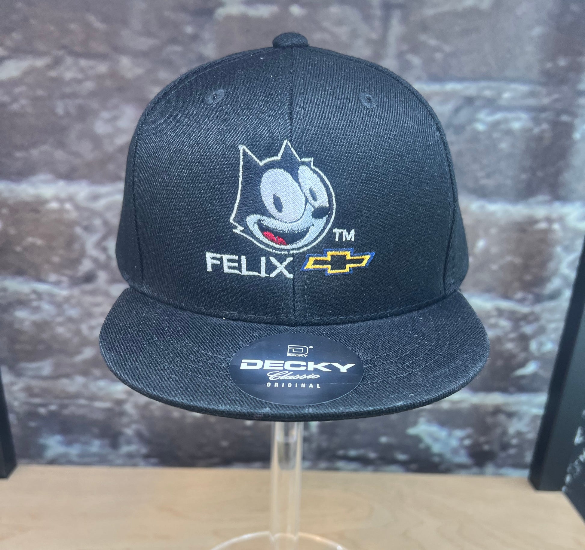 Black youth snapback hat with Felix the Cat and Chevy logo embroidered on the front