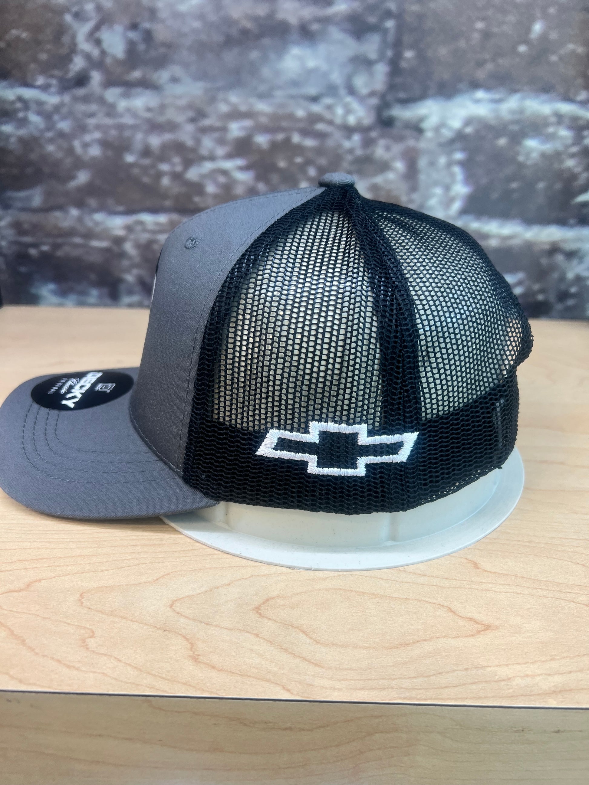 Side angle of Felix youth mesh trucker cap with Chevrolet detail
